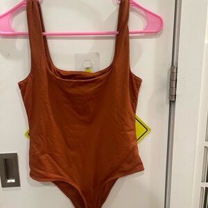 Rust colored body suit